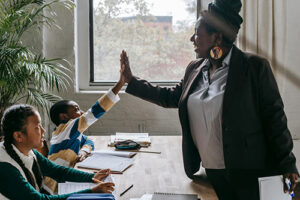 A teacher give a student a high five